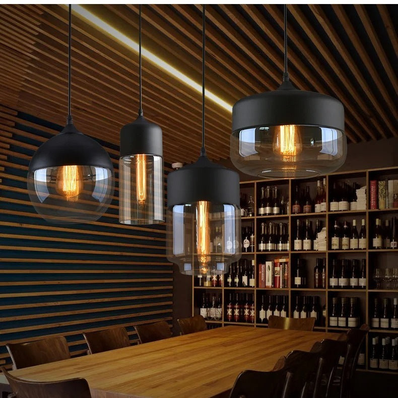 Arlo black and glass pendant lights above a long timber dining table
