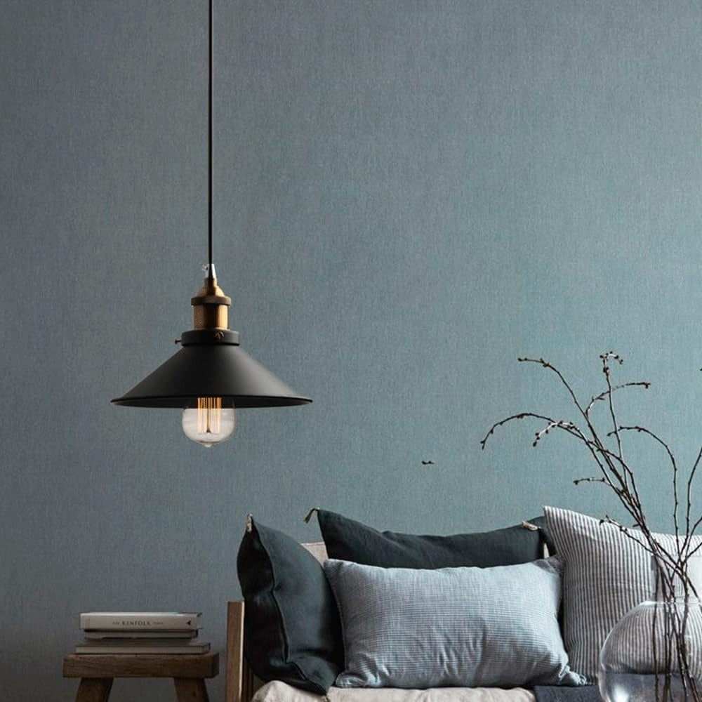 Single black cone industrial pendant with filament bulb in a living room