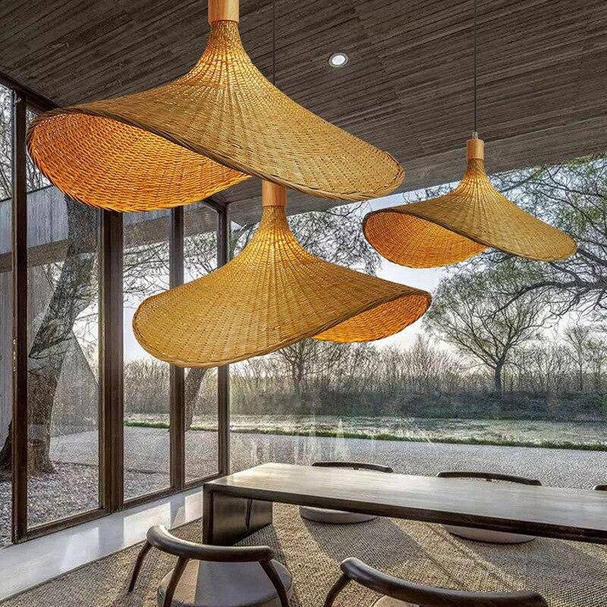 Kasa woven bamboo hat pendant lights over a long dining table