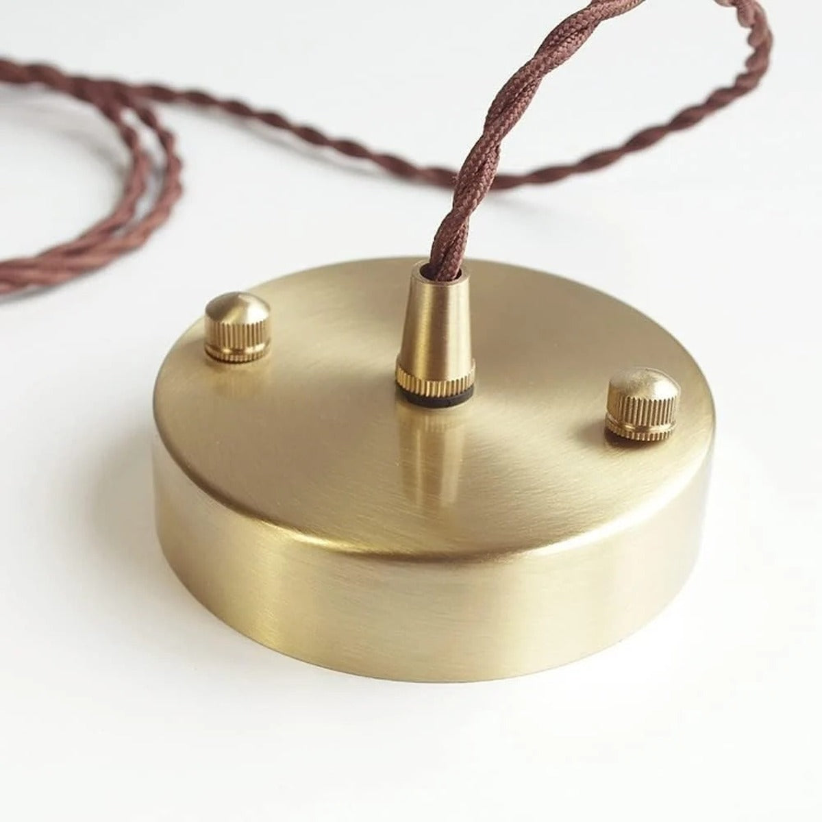 Brass-finish ceiling cup with twisted fabric cord