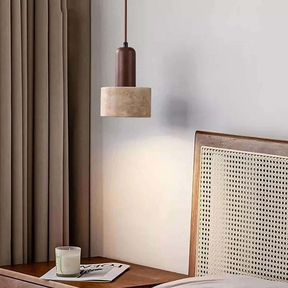Remy travertine and walnut pendant light beside a rattan bedhead and bedside table