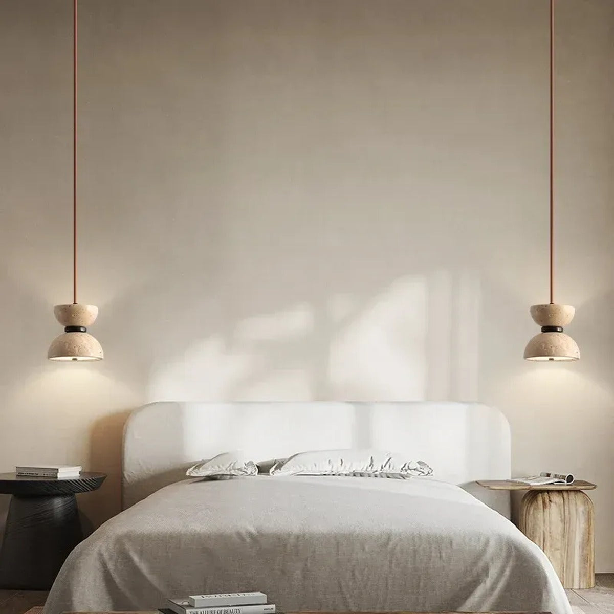 Pair of Sable travertine hourglass pendant lights in a bedroom
