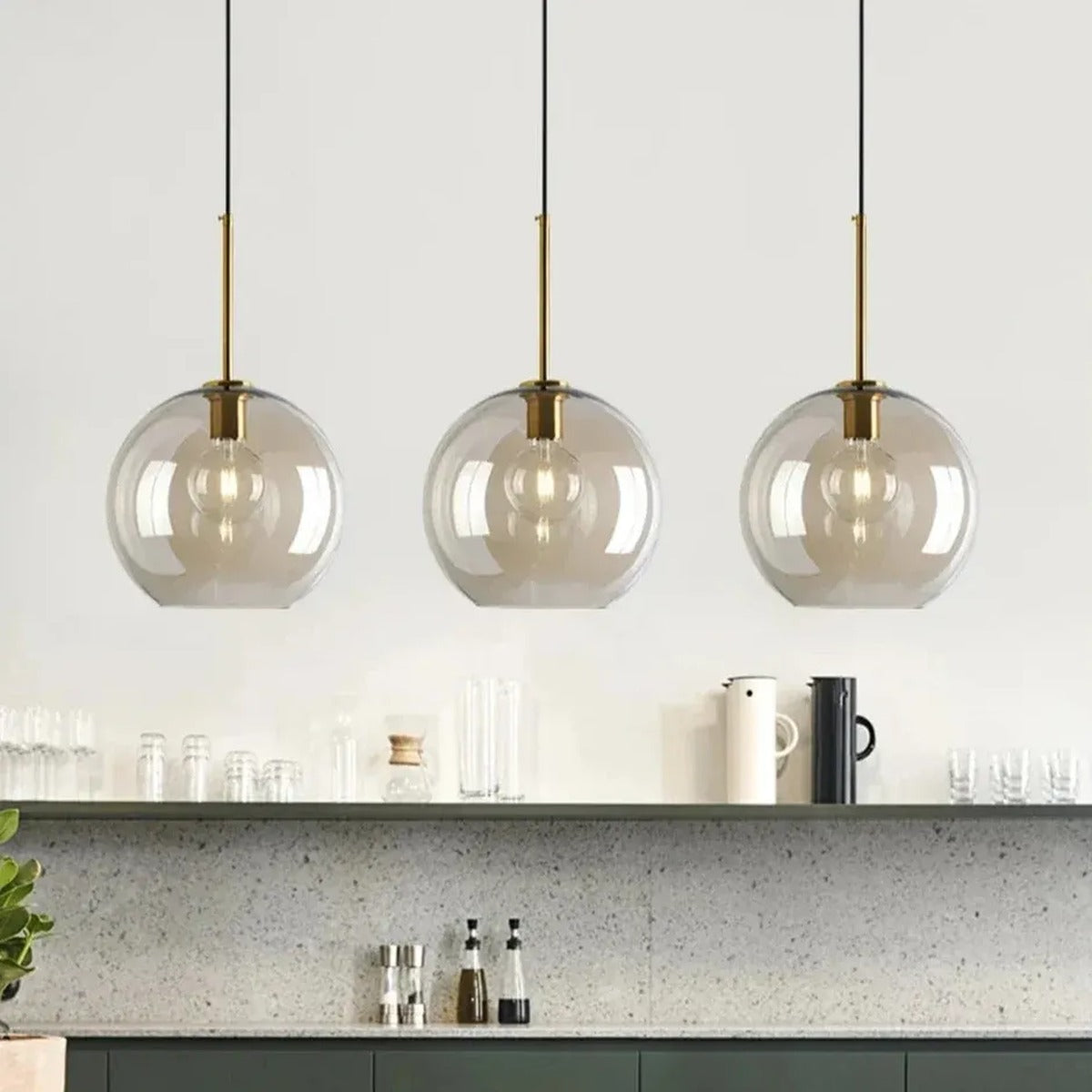 Three Sienna cognac glass globe pendant lights above a kitchen worktop
