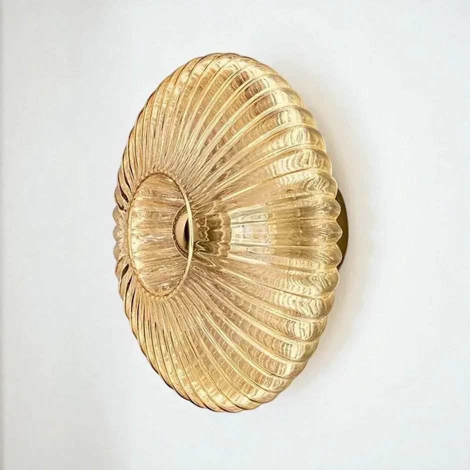 Solene ribbed glass wall light in milky white, switched on