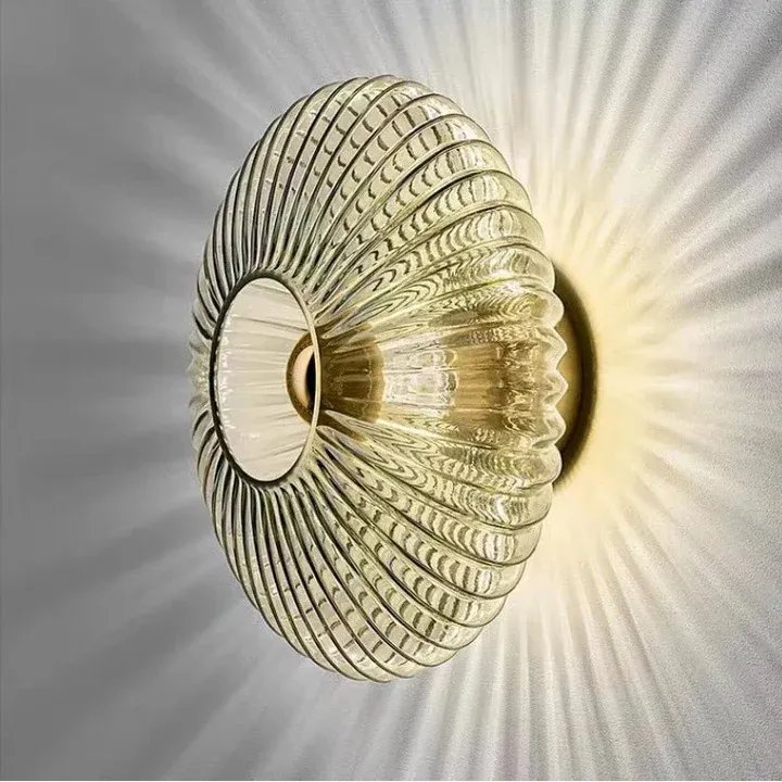 Solene ribbed glass wall light in smoke grey, switched on