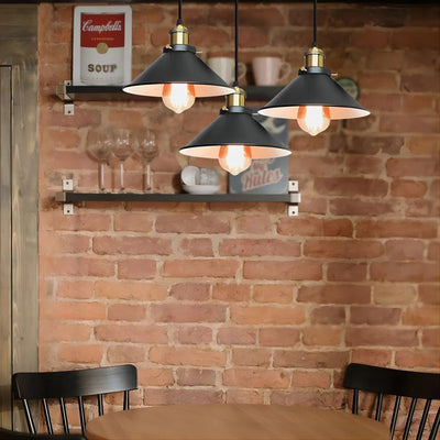 Black cone industrial 3-light cluster pendant over a dining table in a loft kitchen