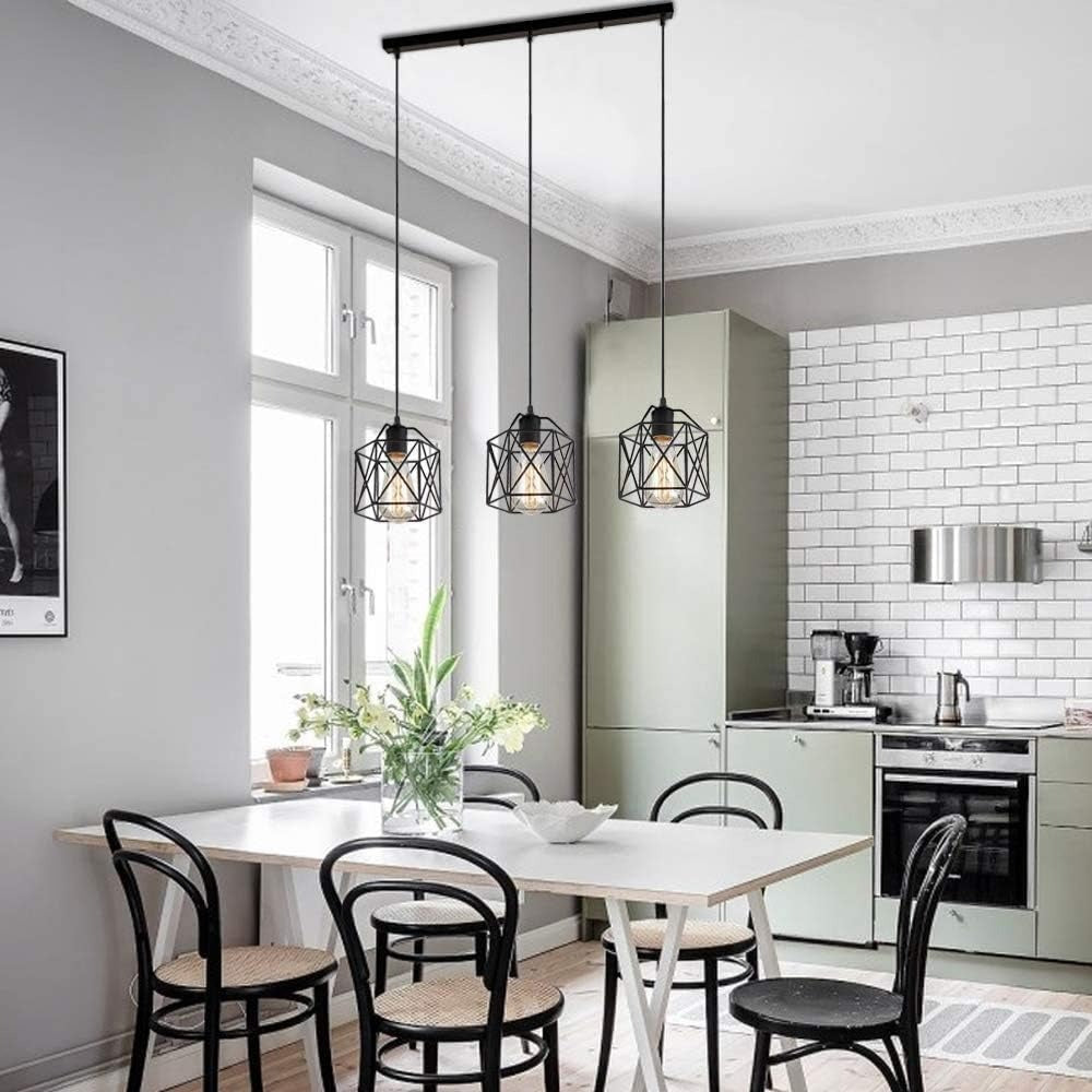 Hudson black cage 3-light pendant bar over a white dining table in a bright kitchen