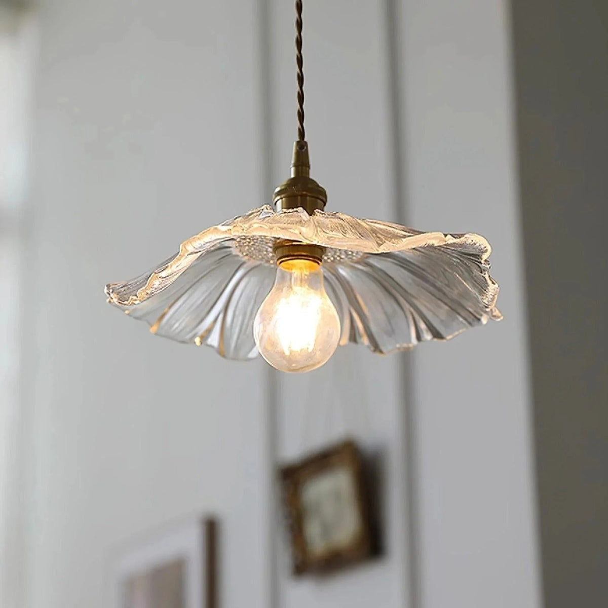 Clear flower glass pendant light switched on