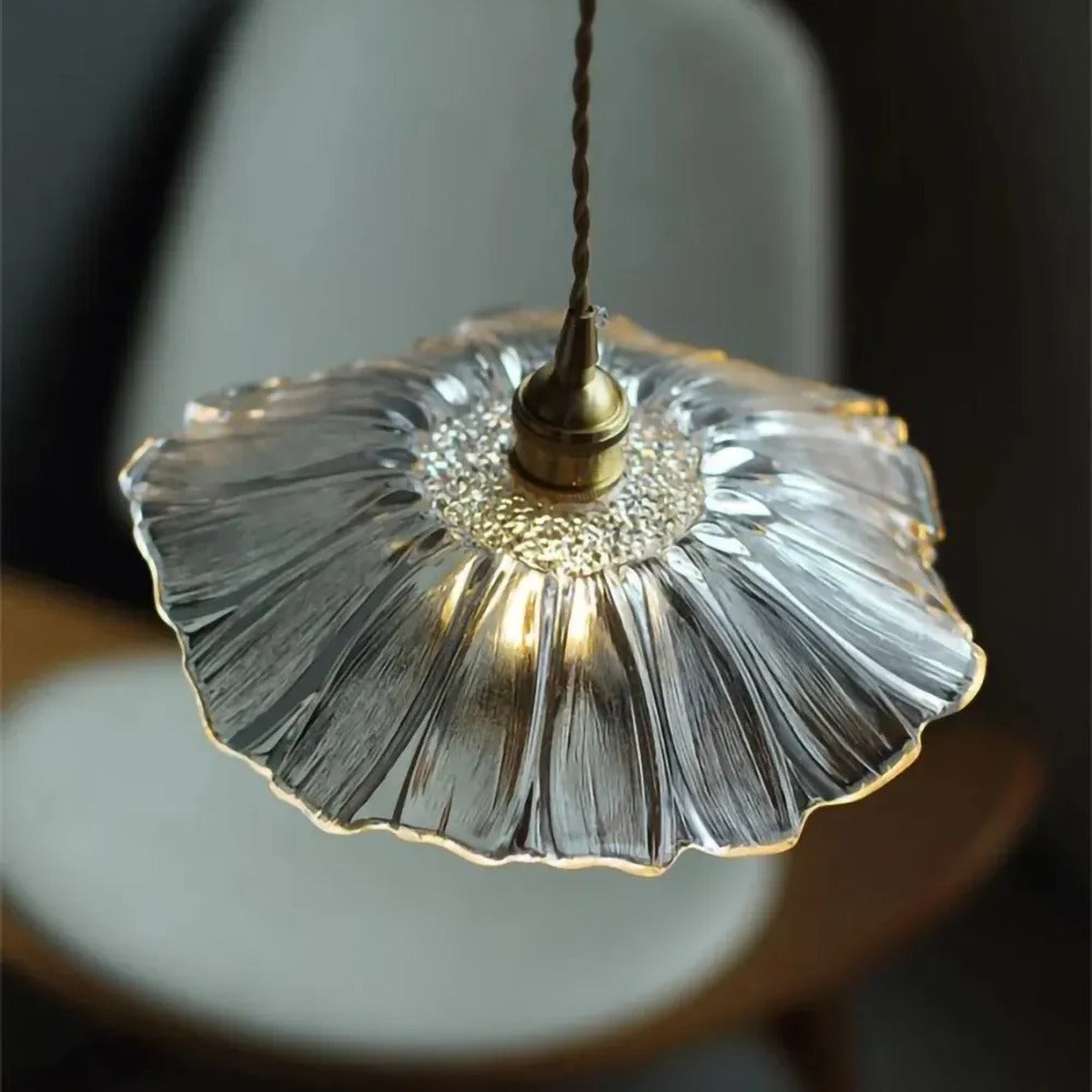 Clear flower glass shade seen from above showing the ribbed petals