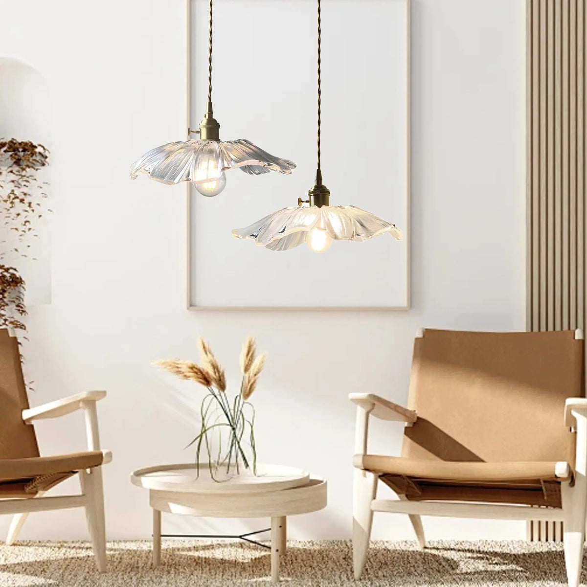 Two clear flower glass pendant lights above a coffee table