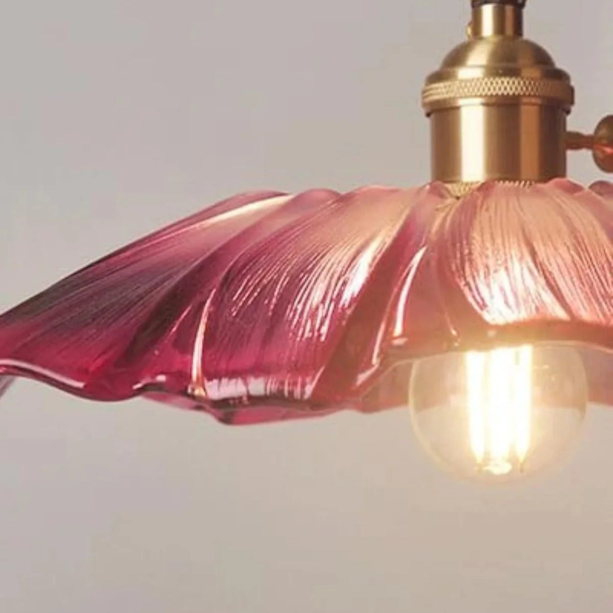 Close-up of the purple flower glass shade and brass holder