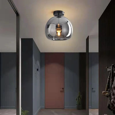 Nordic smoke grey glass globe flush ceiling light with black fittings in a hallway