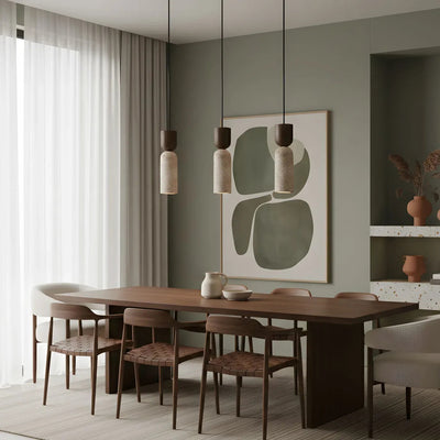 Three Pia travertine and walnut mini pendant lights over a dining table
