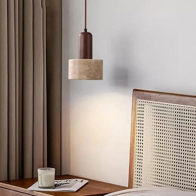 Remy travertine and walnut pendant light beside a rattan bedhead and bedside table