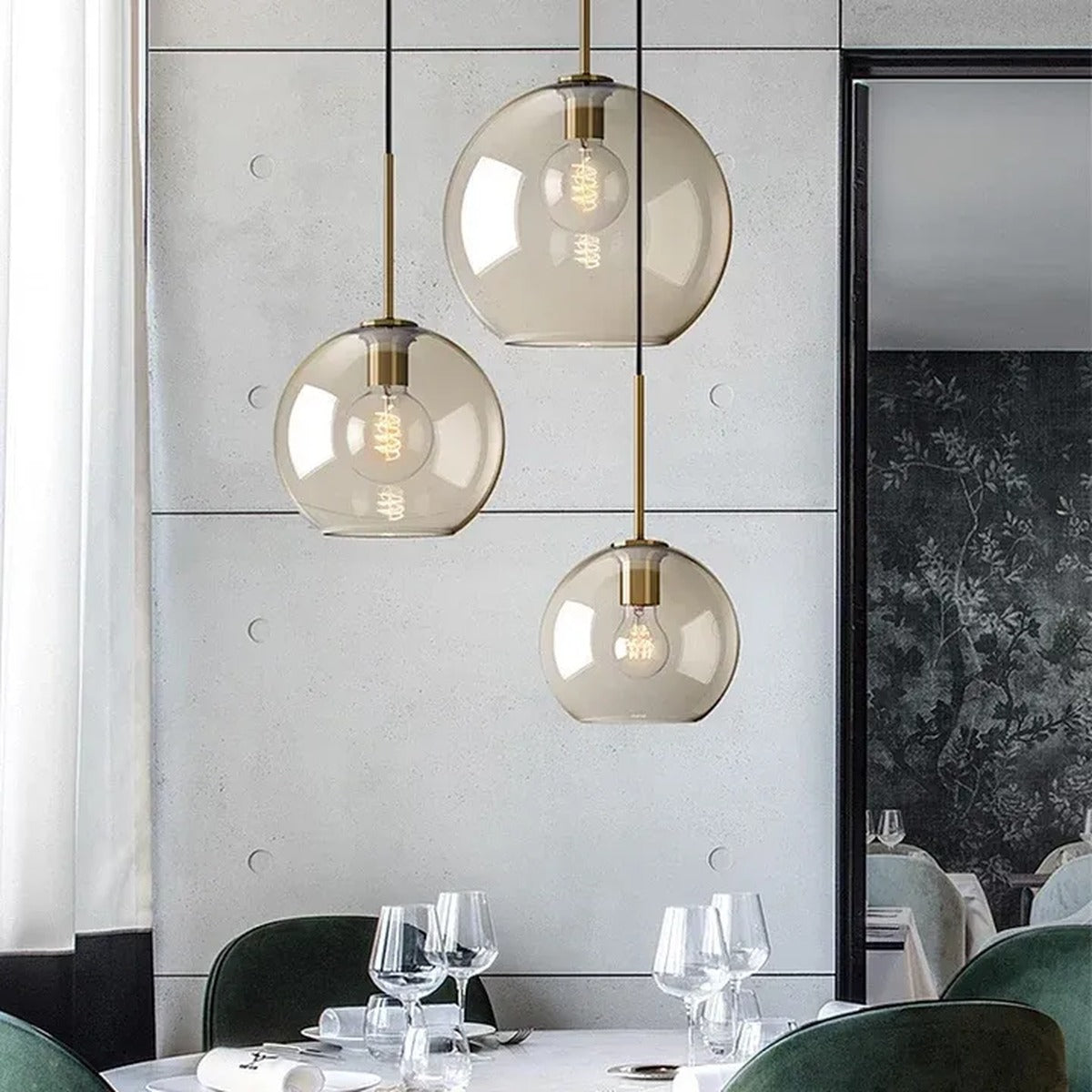 Sienna cognac glass globe pendant lights above a dining table